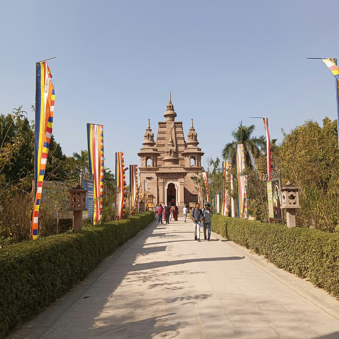 Sarnath Temple, a significant Buddhist site featuring elegant architecture and serene surroundings, marking the location of Buddha's first sermon.
